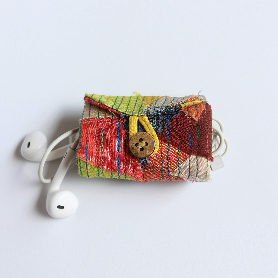 multi-colour cord organiser featuring a button closure