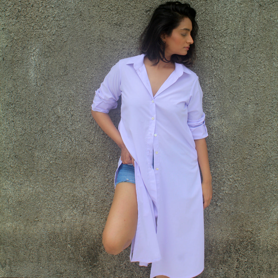 a calf length shirt dress and has pockets on both sides
