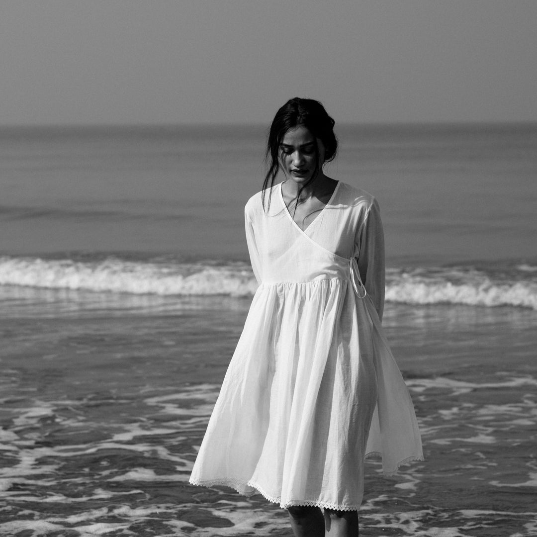 knee length, white mal dress with an overlapping front yoke and side strings