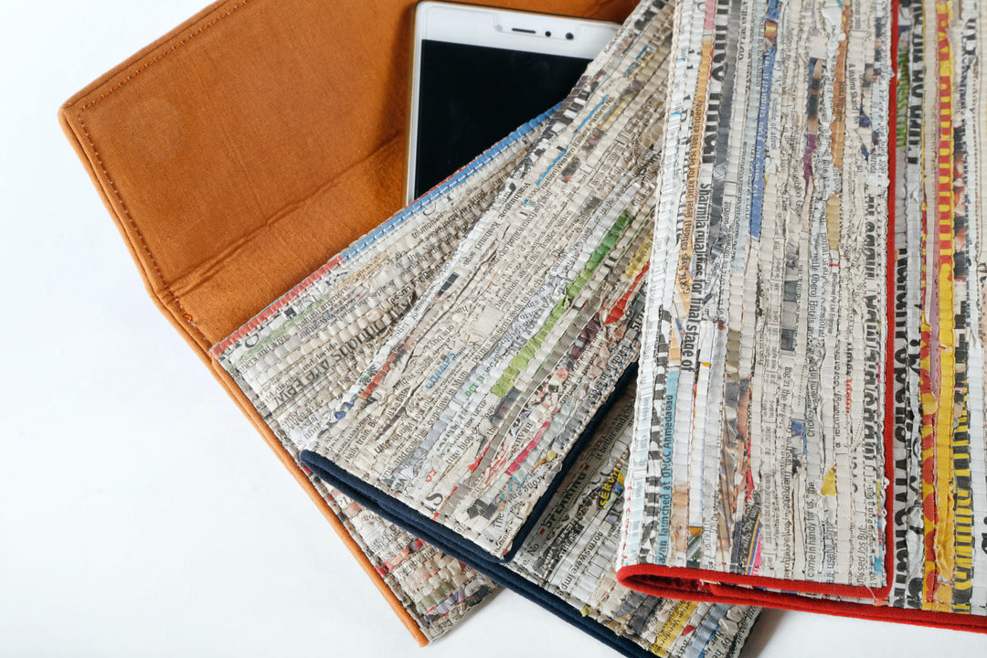 Handmade, functional wristlet made from cotton and newspaper strip comes with burnt orange lining
