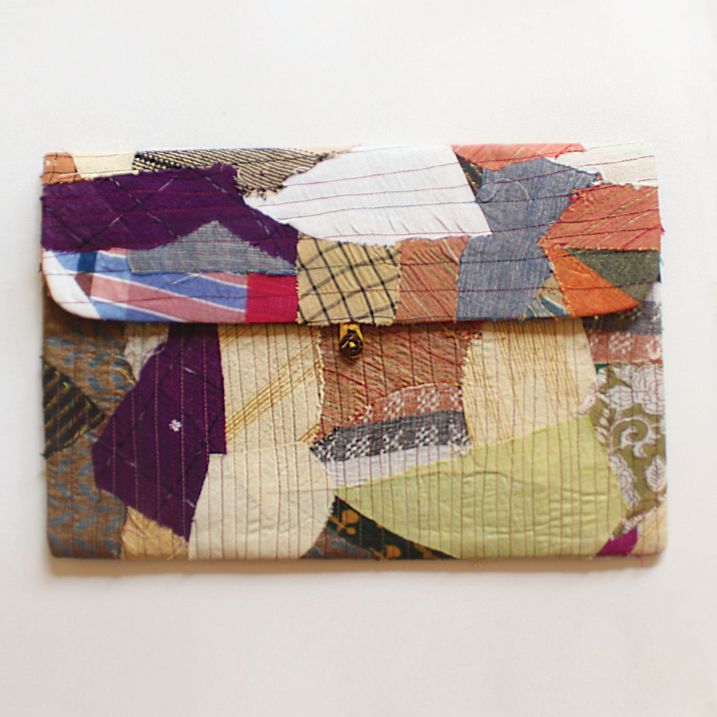The scrap up laptop sleeve has been made using post production scraps. The laptop sleeve has front pockets