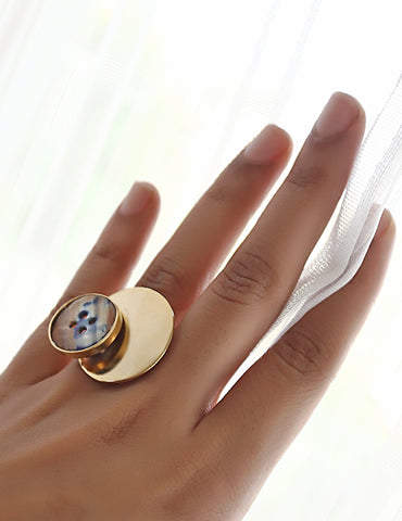 This ring is made using upcycled shell / dyed mother of pearl buttons, slightly tilted at an angle