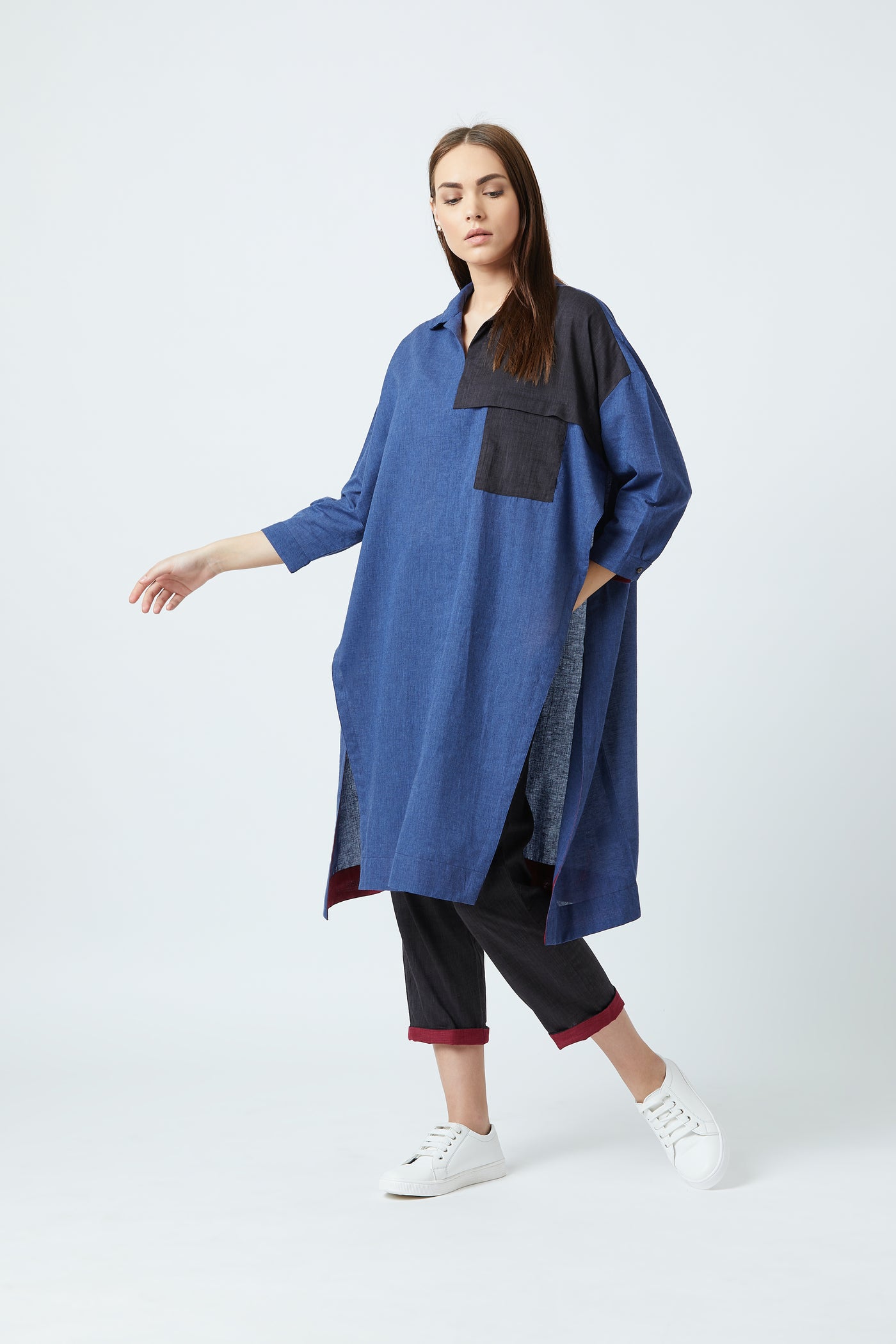 blue oversized tunic featuring long side slits and a black top pocket