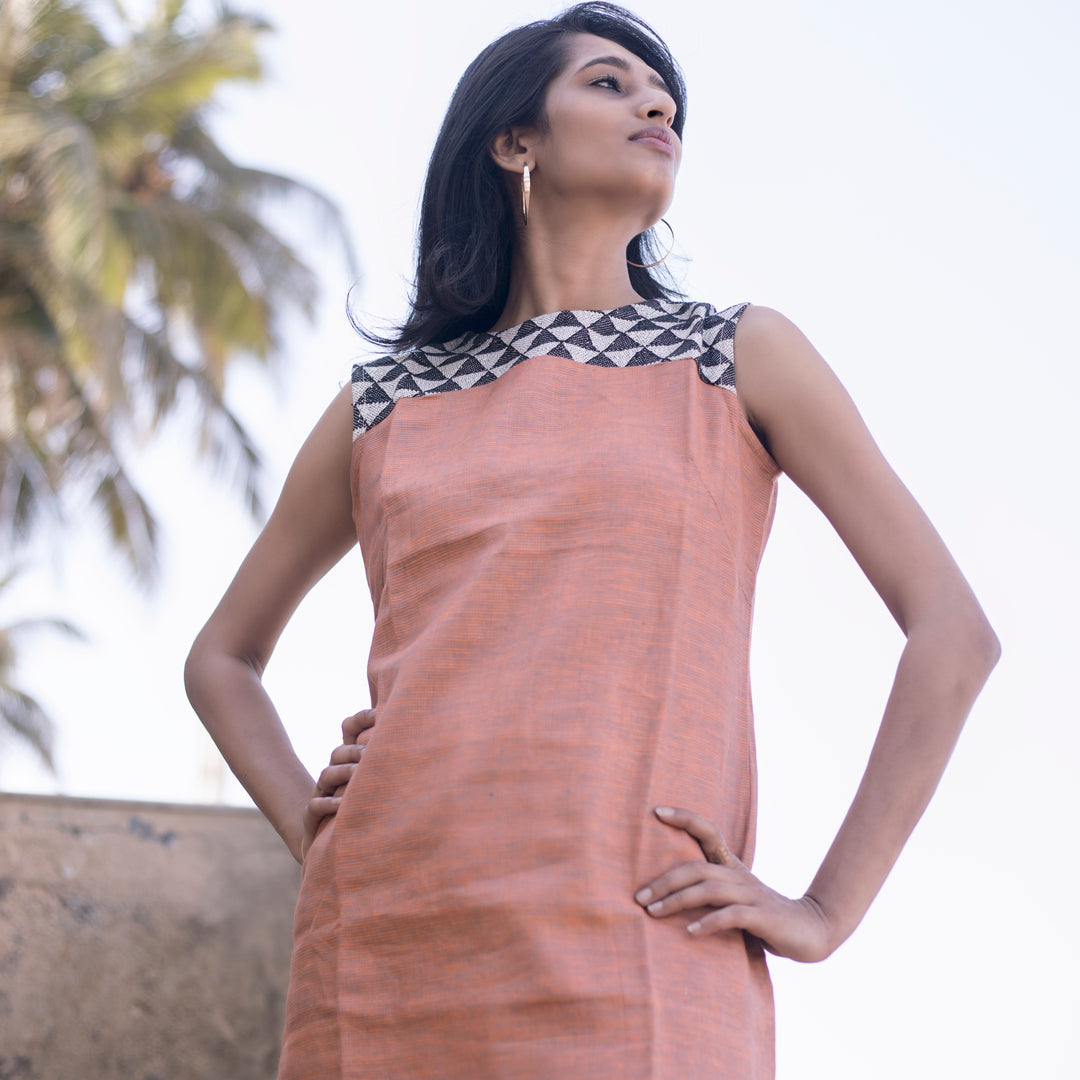 dusky coloured dress with white and black pattern at the top