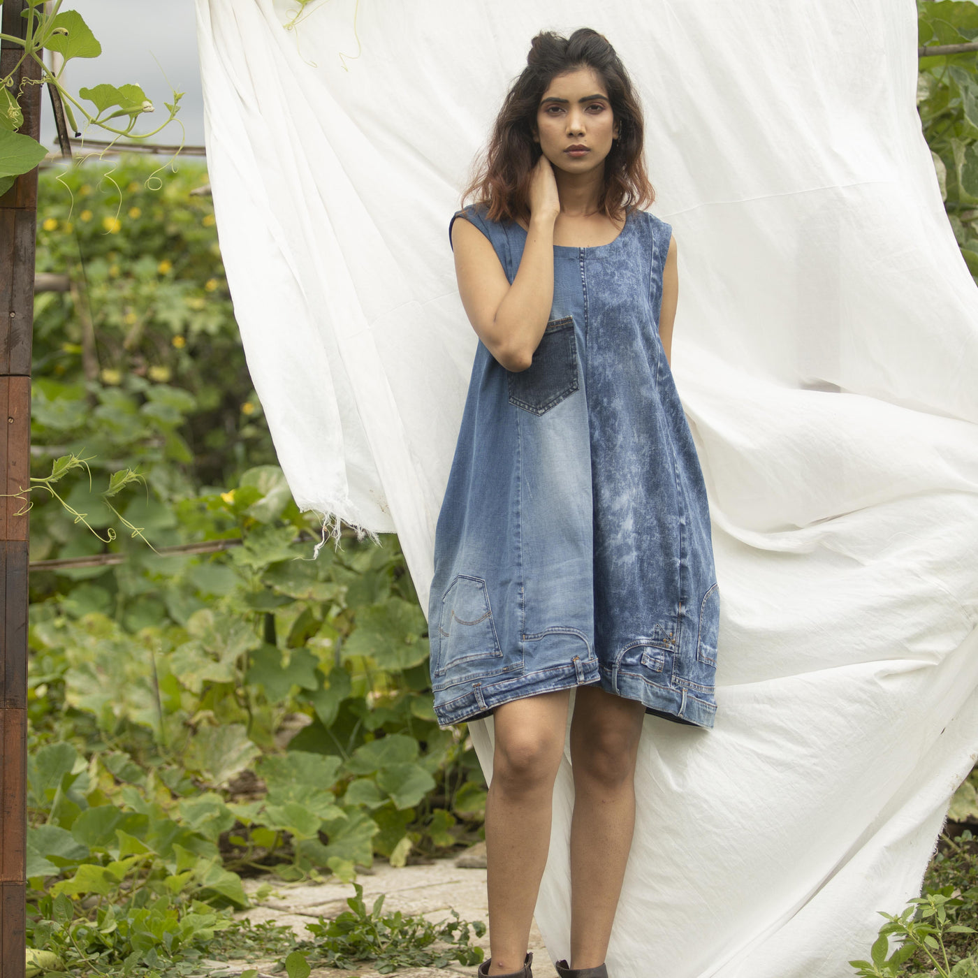 A-line  upcycled denim sleeveless dress with a contrasting chest pocket.