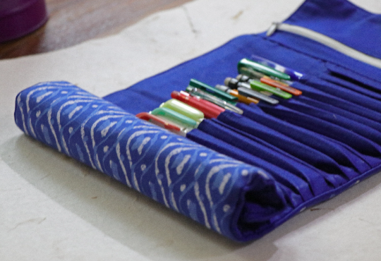 Roll up case with an indigo base & digitally block printed with various shades of white & blue.e.