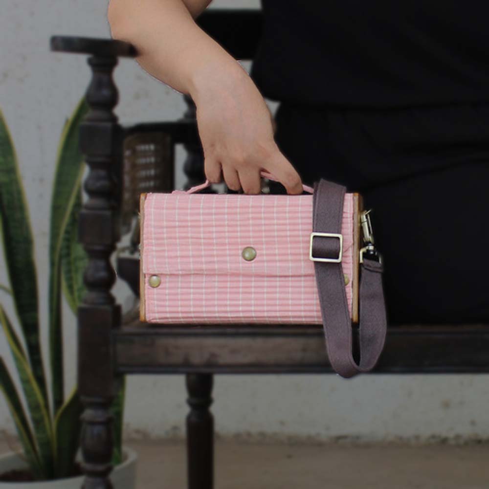 100% handcrafted box clutch comes with a detachable sleeve in baby pink lines.