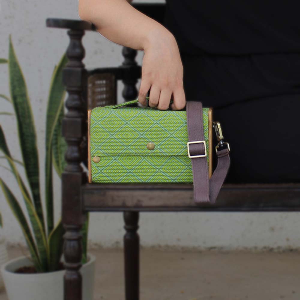 100% handcrafted box clutch comes with a detachable sleeve featuring a Green geometric print.