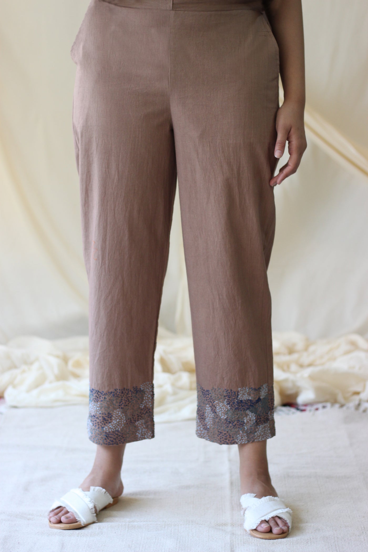 relaxed fit beige pants with abstract embroidery