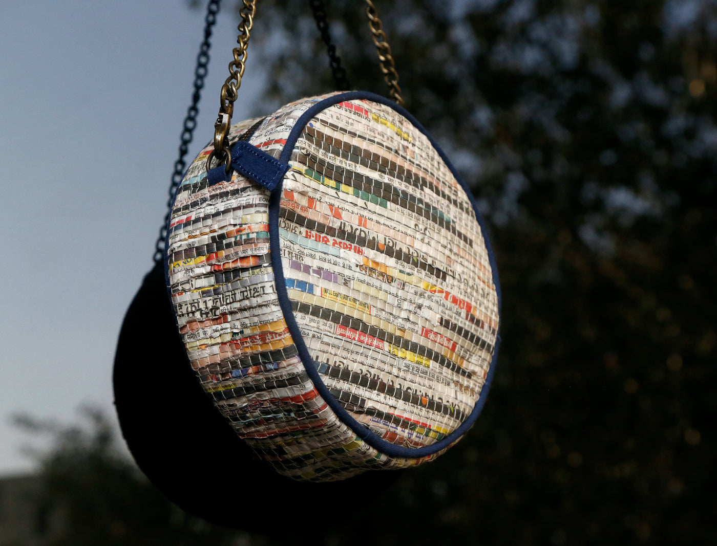 Sling made of handwoven newspaper strips and cotton. Inside lining made of recycled cotton