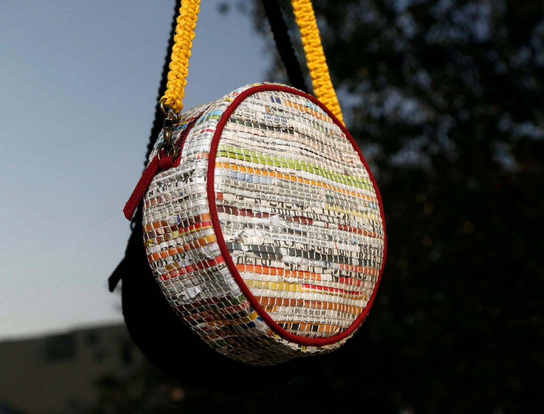 Sling made of handwoven newspaper strips and cotton. Lining is made of recycled cotton fabric.