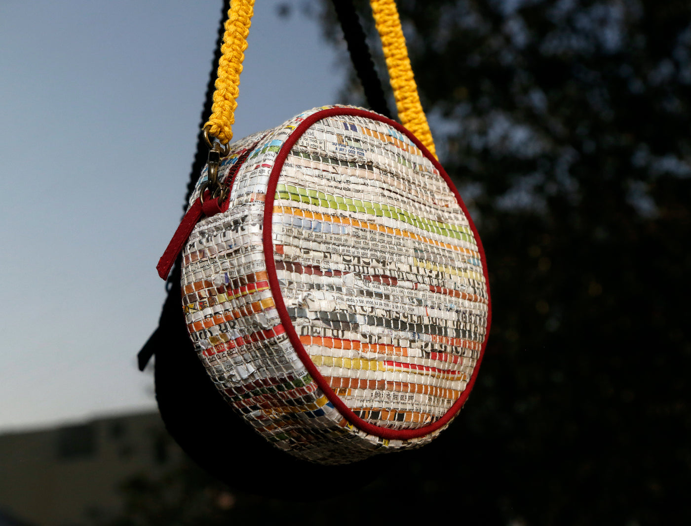 Sling made of handwoven newspaper strips and cotton. Lining is made of recycled cotton fabric.