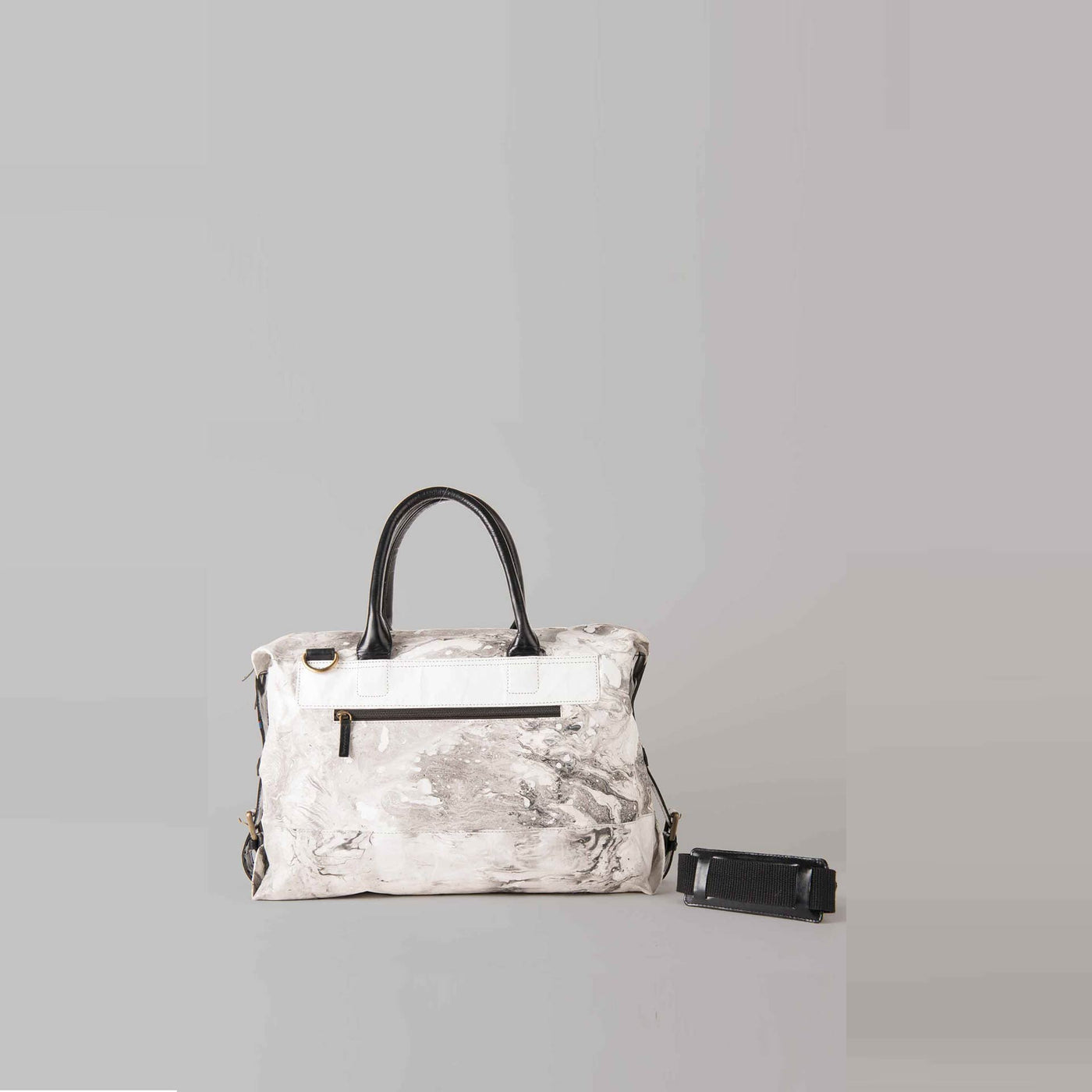 white and black duffle bag which is handcrafted in hybrid material faux leather