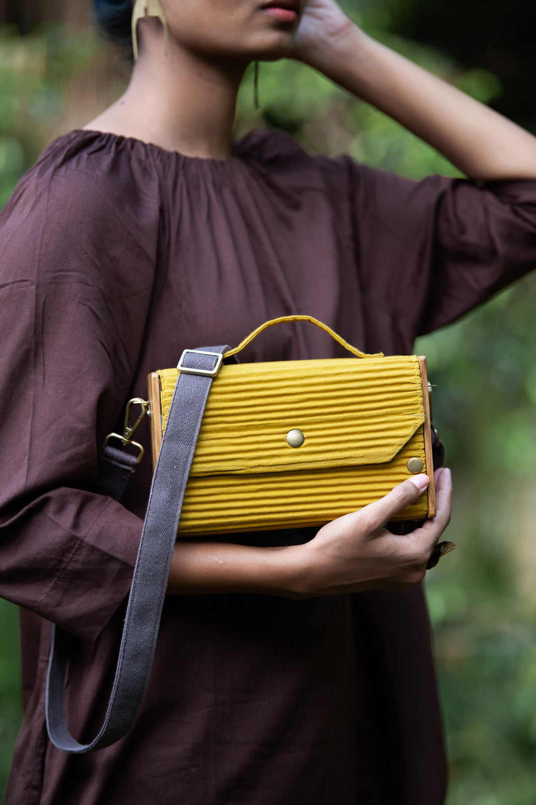 100% handcrafted box clutch comes with a detachable sleeve in baby pink lines.