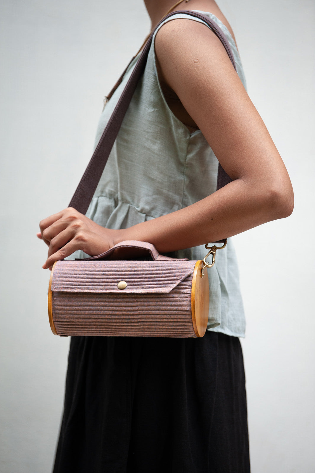 100% handcrafted round clutch comes with 1 detachable sleeve - in a solid mauve shade.