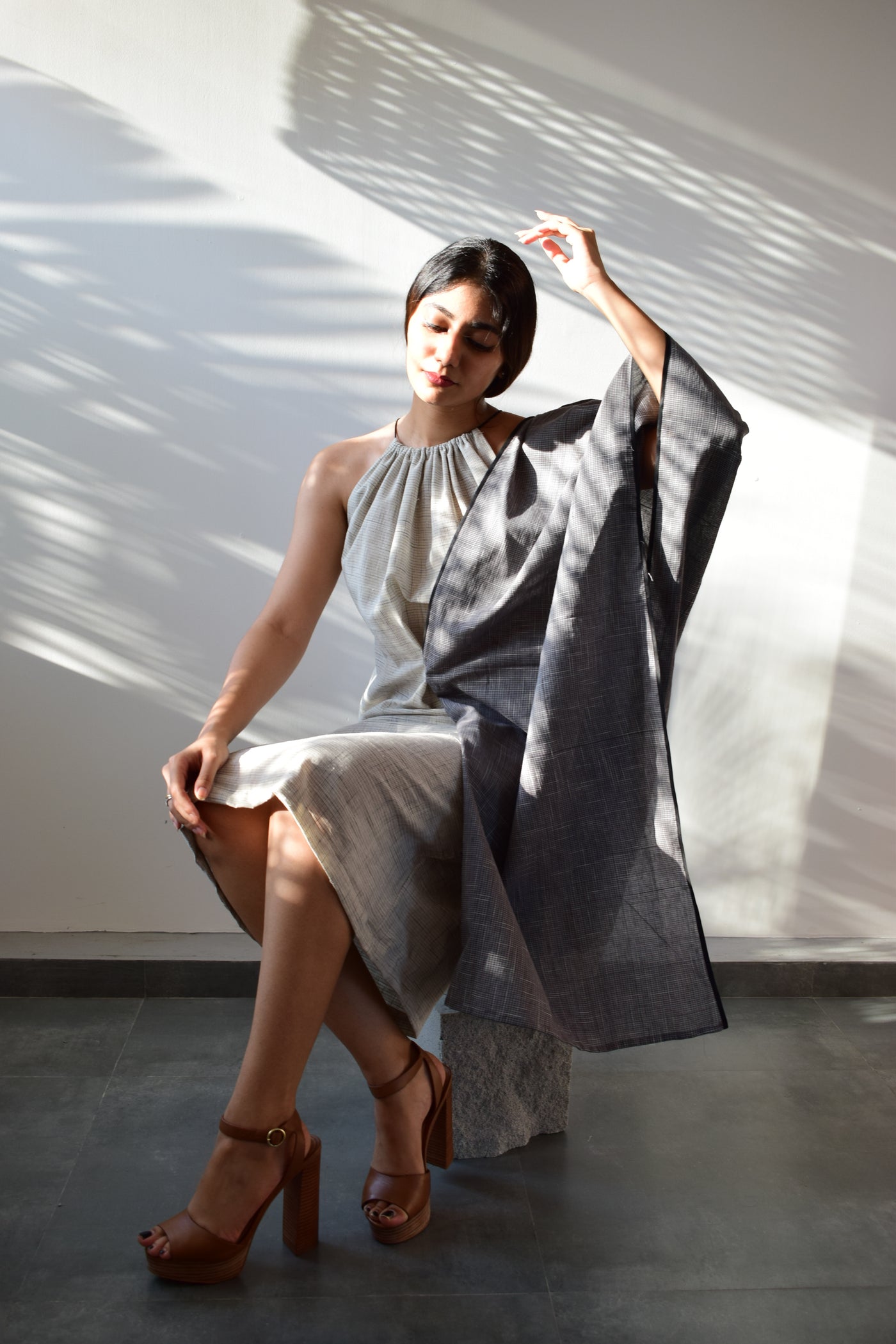 Dress features a gathered halter neckline and a straight fit made from dead-stock handloom cotton.