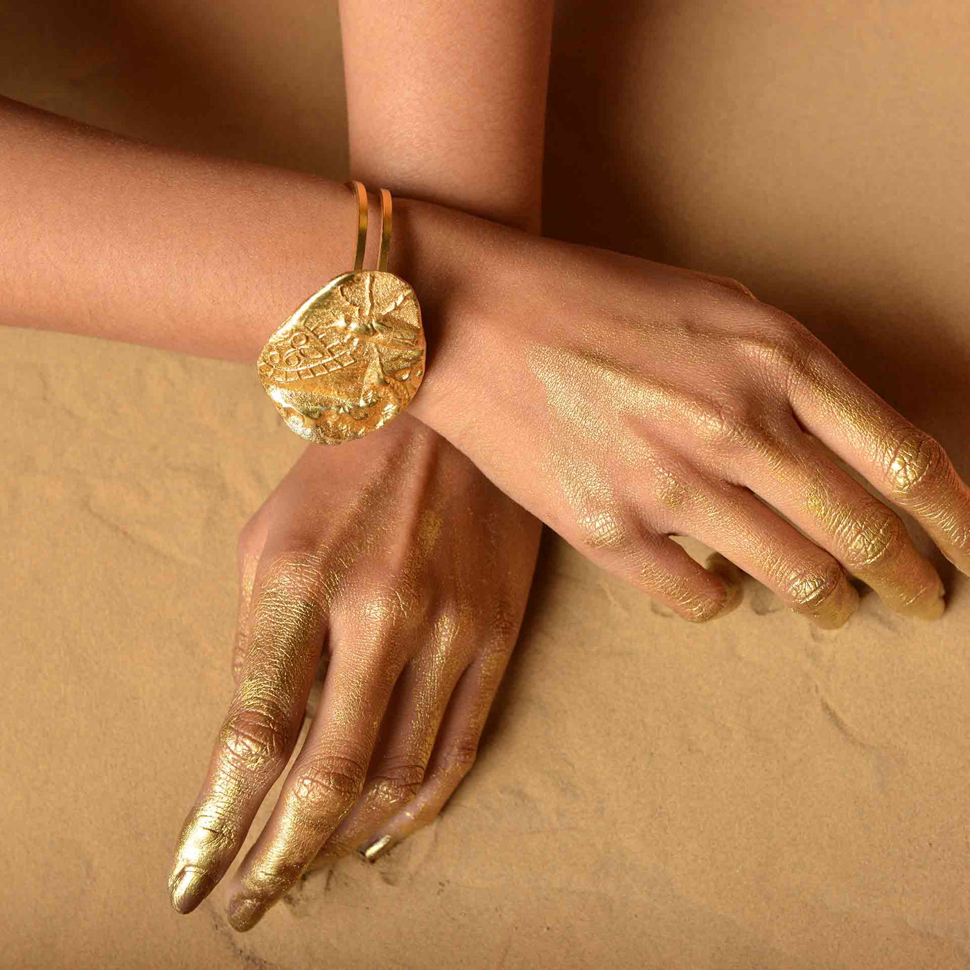 A double cuffed dye gold bracelet which is reminiscent of a fossil.