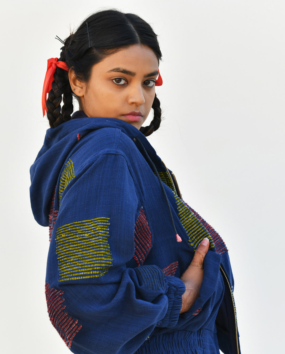 A blue cropped handwoven hoodie jacket