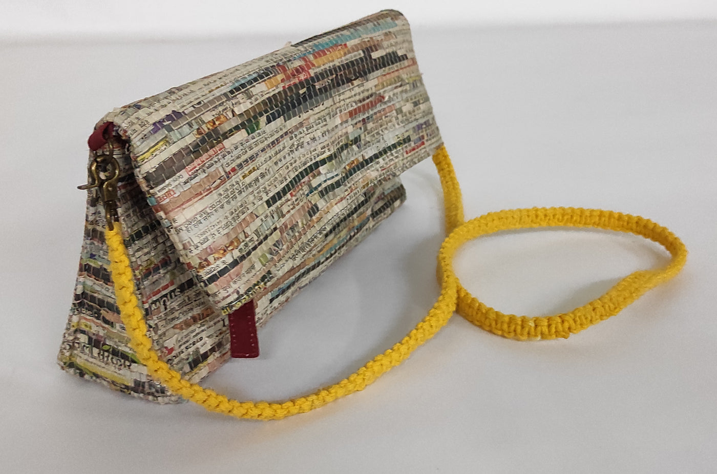 Handcrafted and handwoven with newspaper strips and cotton, newsprint pattern