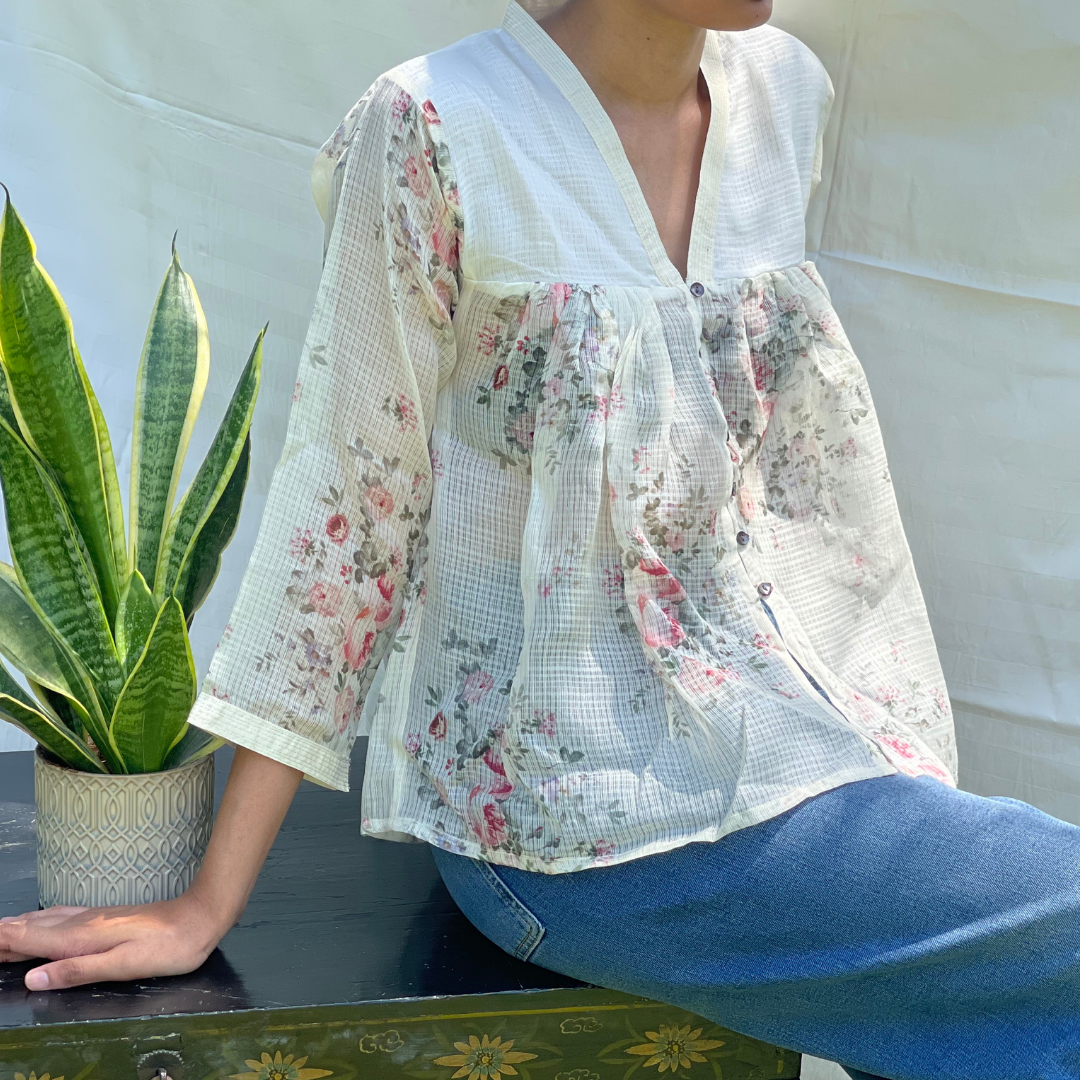 Sleeves top with a V-necked collar intricate silver detail on the collar and cuff of the sleeves.