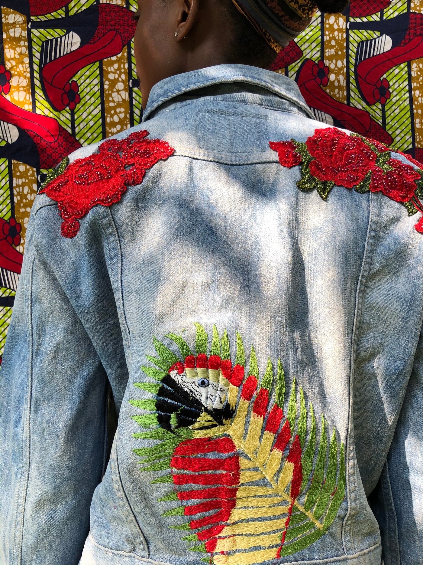 It features wire and bead embellishment design along with a pocket flap with a unique parrot design