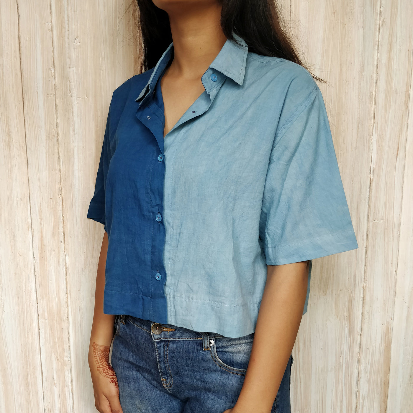 a denim flared and breezy skirt with kantha embroidery on the pocket opening and on the button.