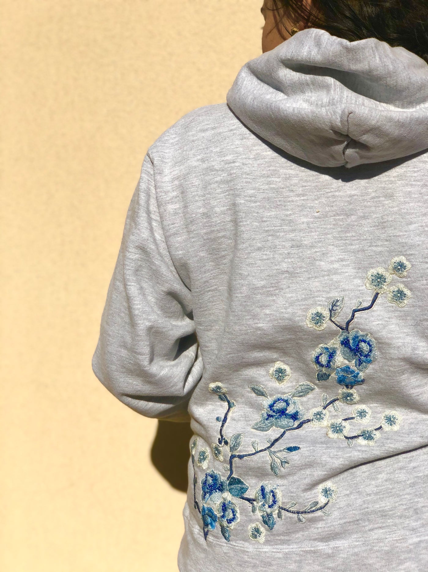 Upcycled Champion hoodie embroidered meticulously in shades of blue on the back