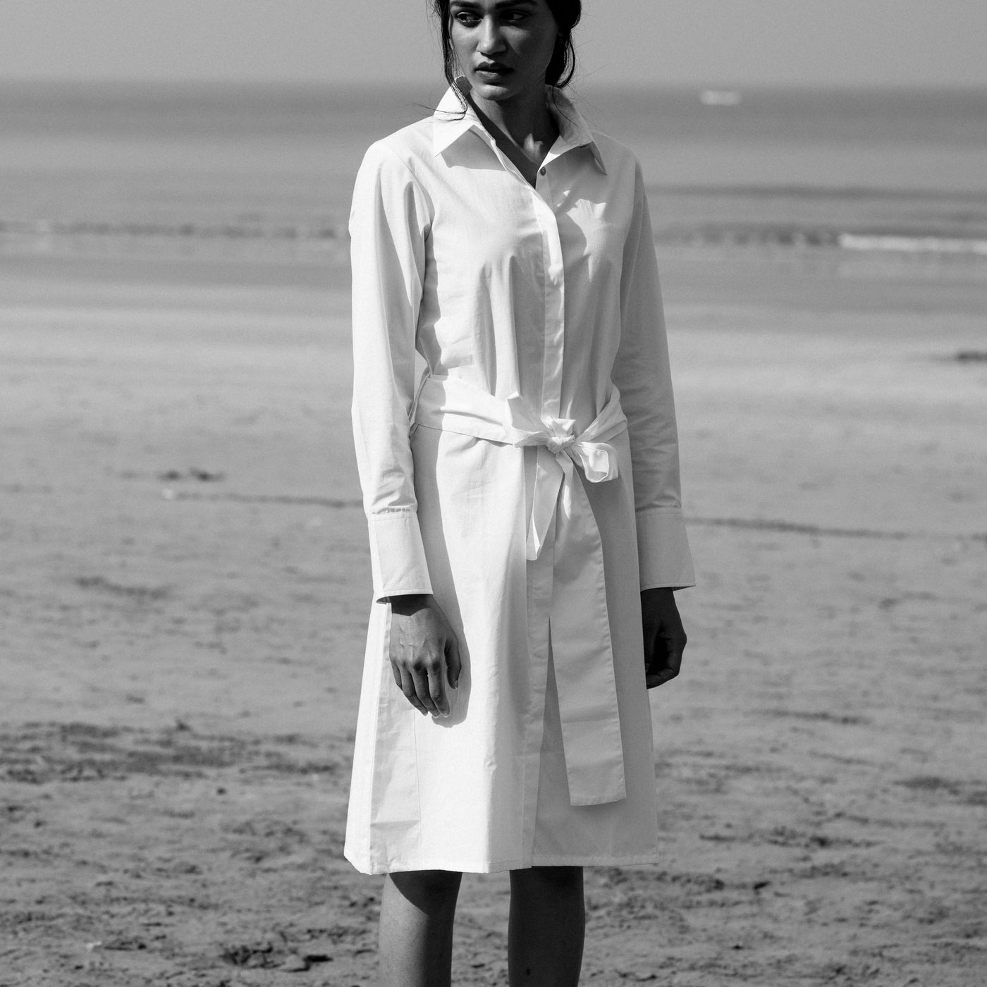 white poplin shirt style dress with a shirt collar and a concealed front placket.