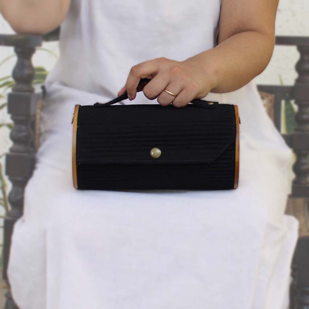 100% handcrafted box clutch comes with a detachable sleeve in black shade.