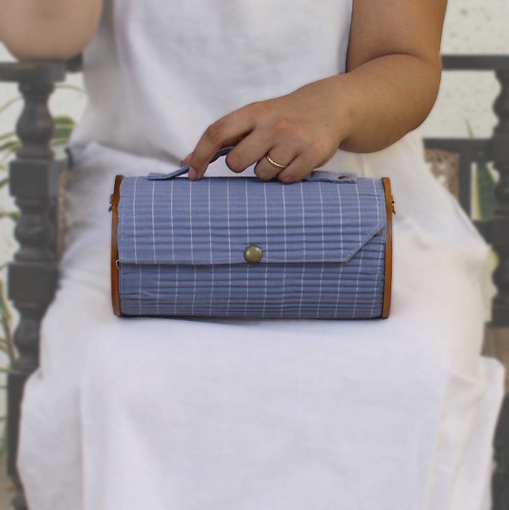 100% handcrafted round clutch comes with 1 detachable sleeve - featuring sky blue lines.