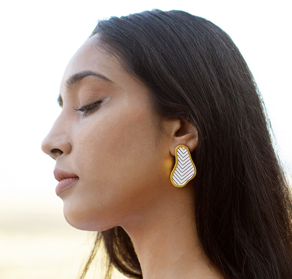 The earrings are handcrafted using reclaimed teak wood and gold plated brass.