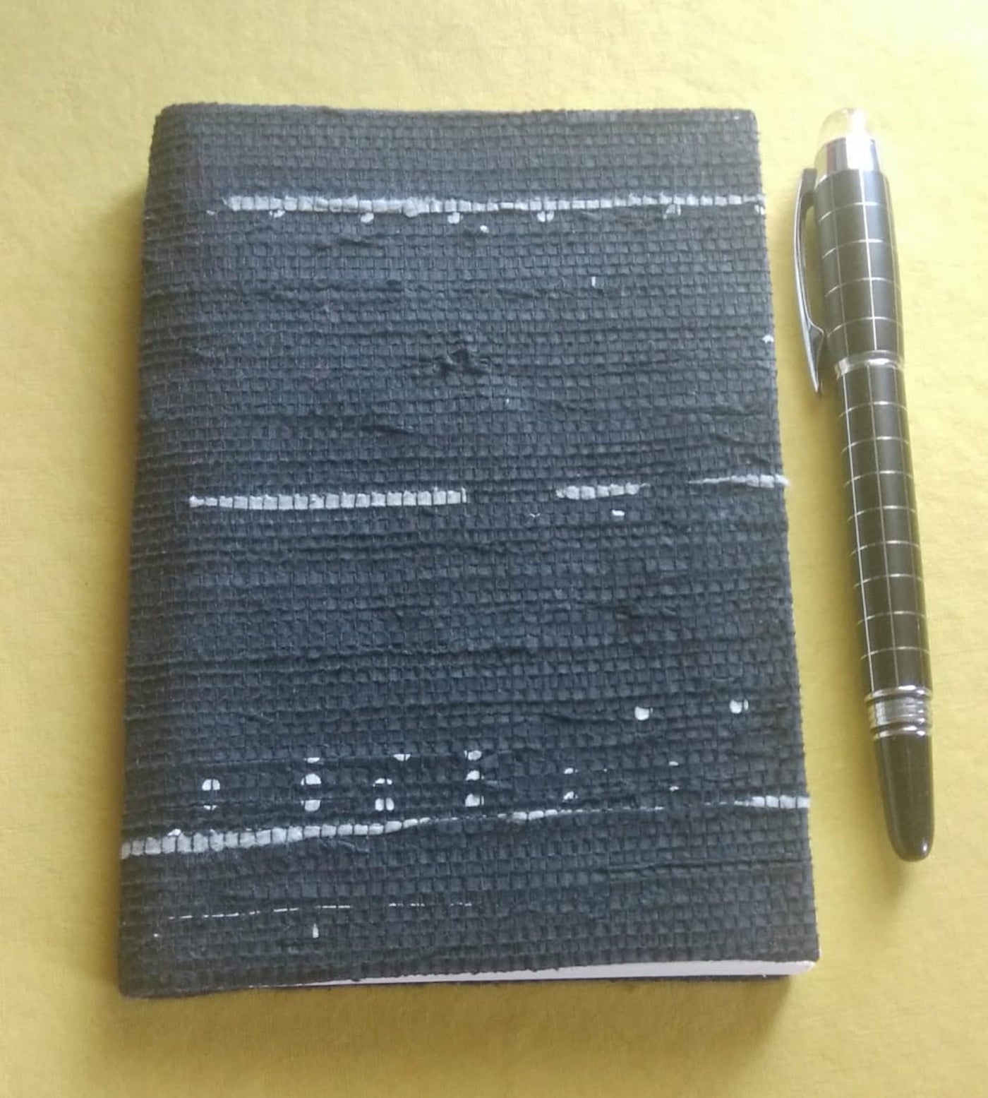 This diary is made with recycled cotton handmade paper and is covered in hand woven newspaper