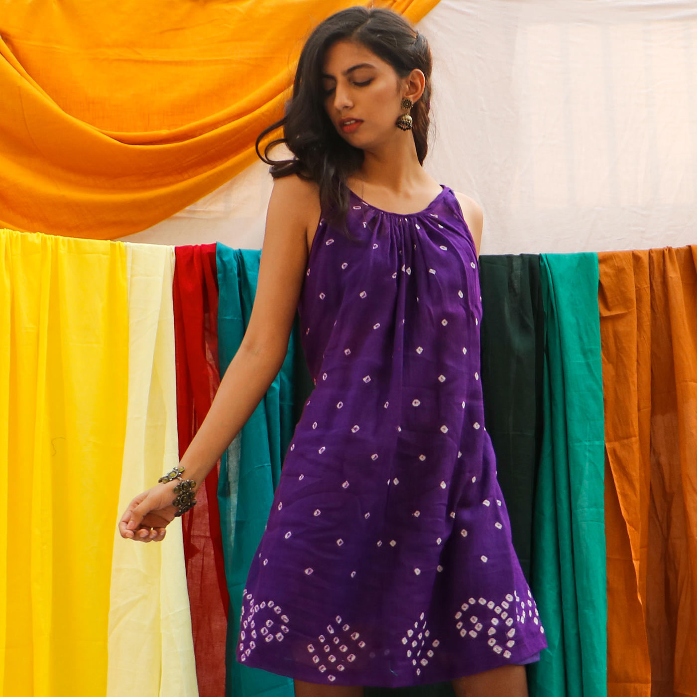 mini bandhani dress features drawstrings at the waist to tie at the back and comes with a slip dress to wear underneath.