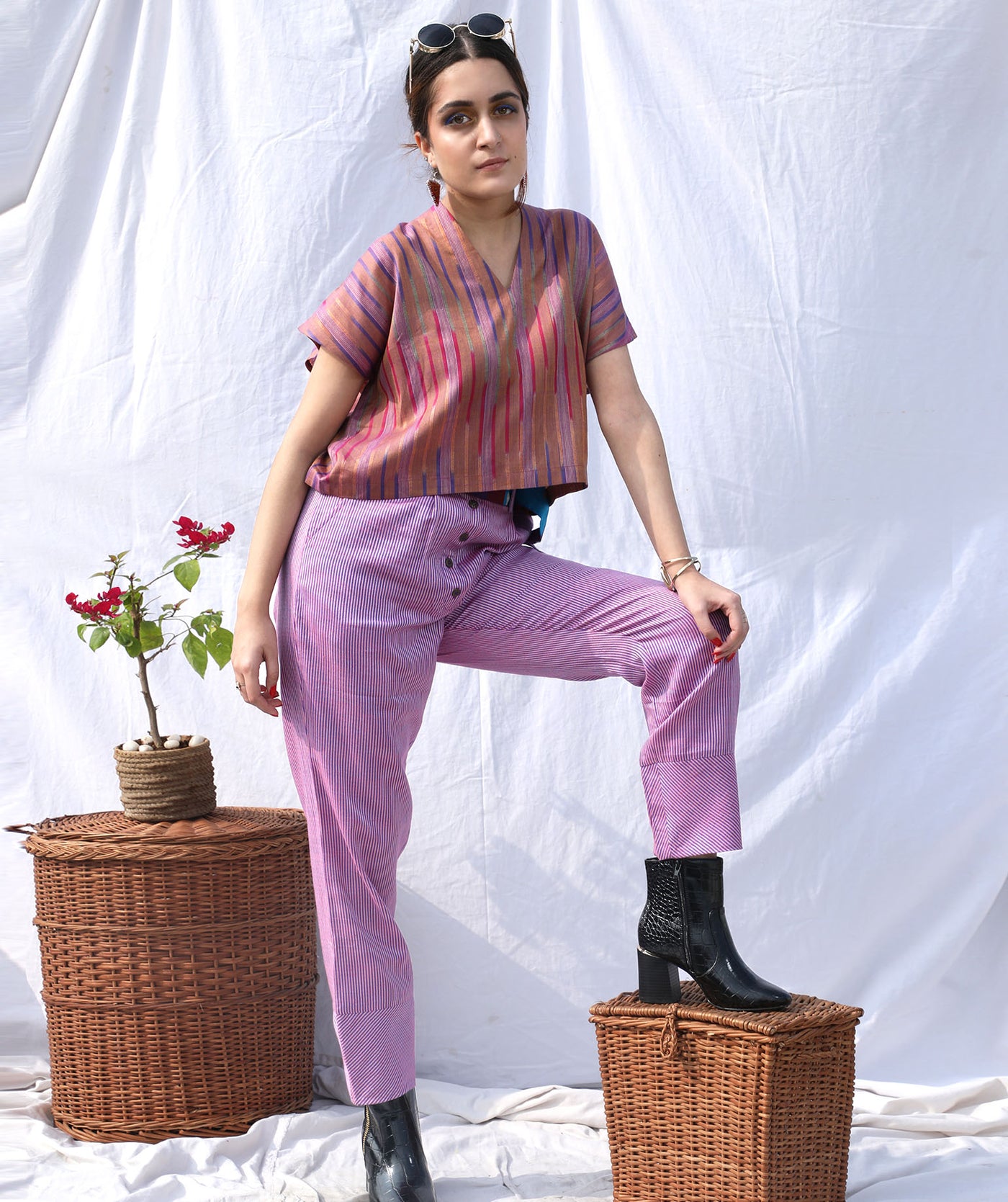 Purple checkered pants is made out of handloom cotton with coconut buttons and has a curved hem.