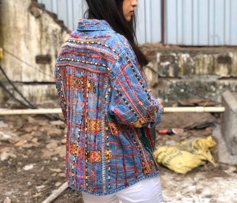 Woven embroidered jean jacket with floral patches appliqued onto this denim jacket.