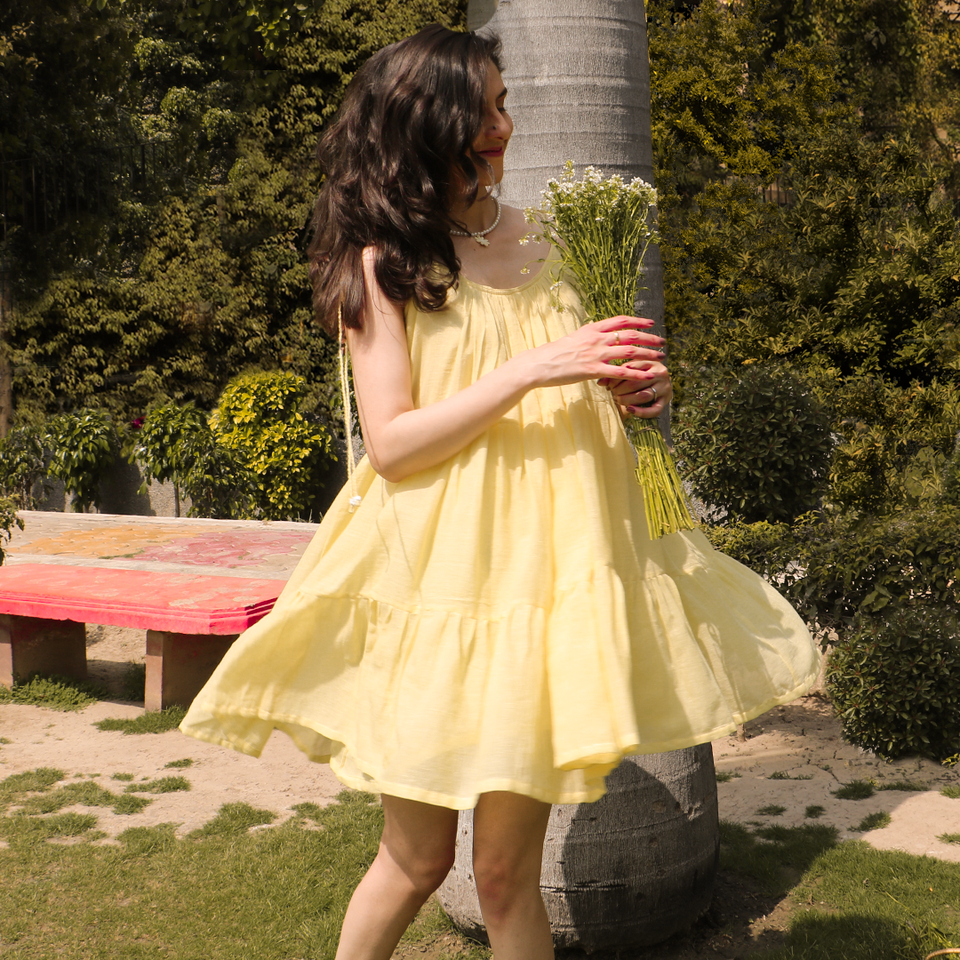Golden yellow dress with hand embroidered floral details and twisted straps with beaded details.